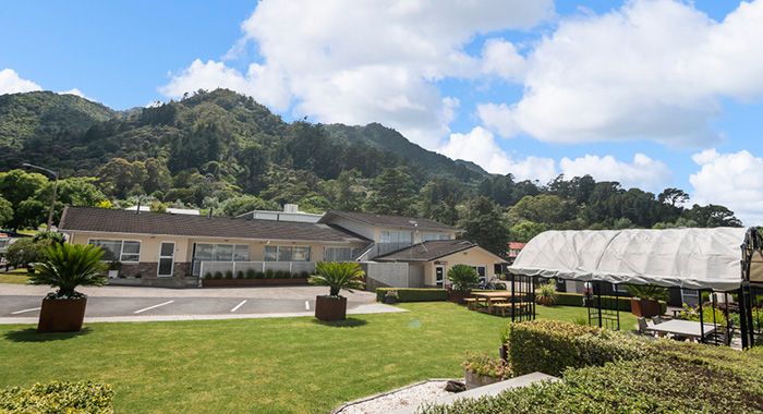 the motel has a large lawn with outdoor seating